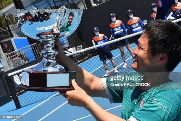 Japan's Shingo Kunieda poses with the trophy after winning against Britain's Alfie Hewett during their men's wheelchair singles final match on day...