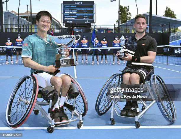 Shingo Kunieda of Japan and Alfie Hewett of Britain hold the winner's and runner-up's trophies, respectively, for the men's wheelchair singles at the...