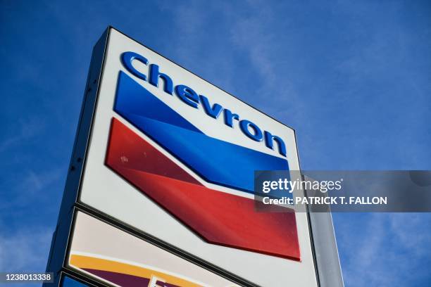 The Chevron logo is displayed at a Chevron gas station on January 26, 2022 in El Segundo, California. - The oil refinery supplies motor vehicle fuels...