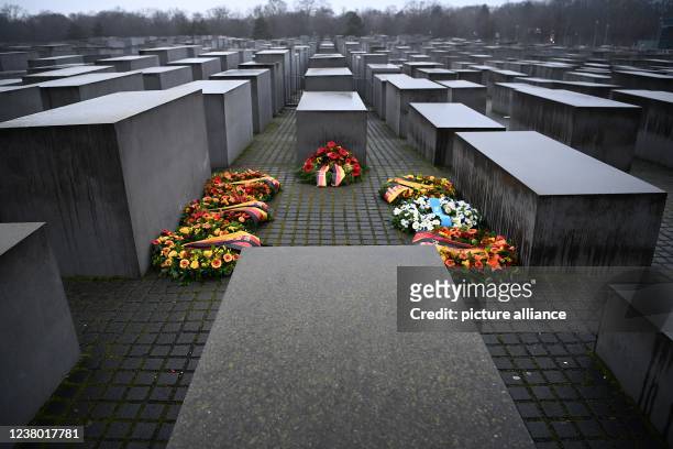 January 2022, Berlin: Wreaths of flowers lie between the stelae at the Memorial to the Murdered Jews of Europe, also called the Holocaust Memorial,...
