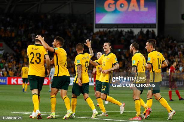 Australia's Tomas Rogic celebrates with teammates after scoring a goal during the FIFA World Cup Qatar 2022 football qualification match between...