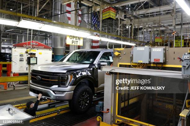 Worker inspects the 40 millionth Ford Motor Co. F-Series truck on the assembly line at the Ford Dearborn Truck Plant on January 26, 2022 in Dearborn,...