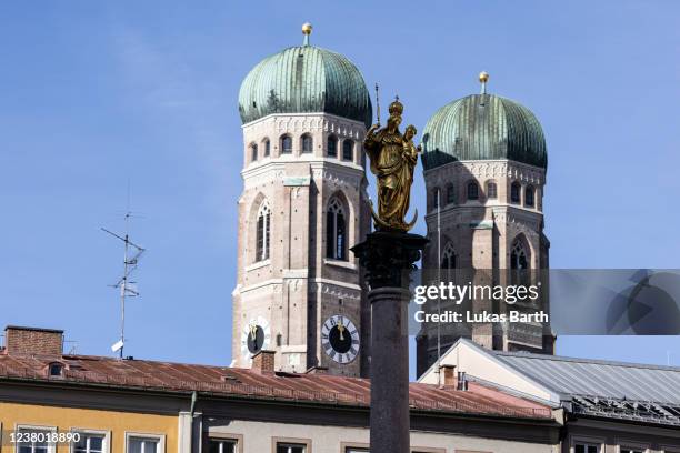 The towers of the Frauenkirche cathedral are seen behind the statue of the Virgin Mary on January 27, 2022 in Munich, Germany. Cardinal Reinhard...