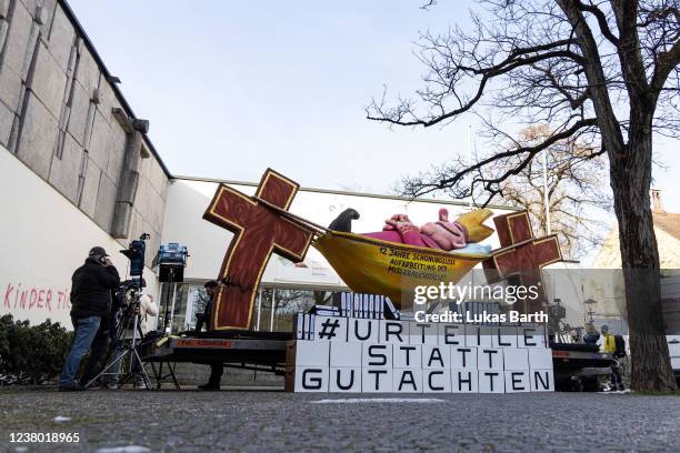 Paper-mache figure showing a sleeping cleric to protest against sexual abuse by Catholic priests is pictured in front of the Catholic Academy in...