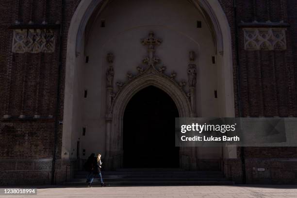 People walk in front of the Frauenkirche cathedral on January 27, 2022 in Munich, Germany. Cardinal Reinhard Marx, the Archbishop of the Roman...