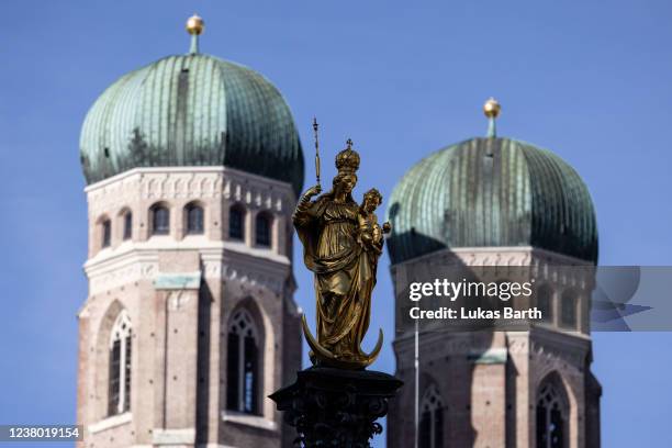 The towers of the Frauenkirche cathedral are seen behind the statue of the Virgin Mary on January 27, 2022 in Munich, Germany. Cardinal Reinhard...