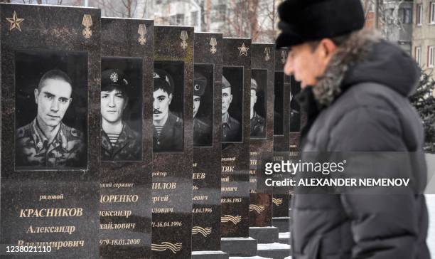 Man walks past a monument to the soldiers killed in action during wars in Afghanistan and Chechnya in the village of Shebekino outside Belgorod, a...