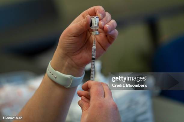 Healthcare worker prepares a dose of the Pfizer-BioNTech Covid-19 vaccine at a vaccination clinic in the Peabody Institute Library in Peabody,...