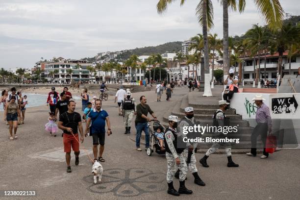 Members of the National Guard patrol the Malecon boardwalk in Puerto Vallarta, Jalisco state, Mexico, on Sunday, Jan. 23, 2022. Tourism will bring in...