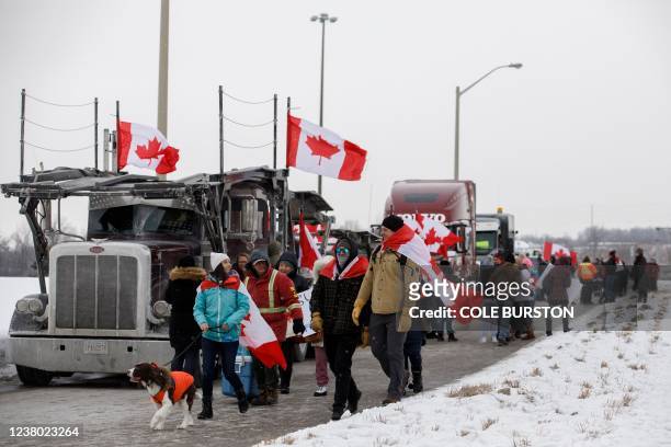 Supporters for a convoy of truckers driving from British Columbia to Ottawa in protest of a Covid-19 vaccine mandate for cross-border truckers,...