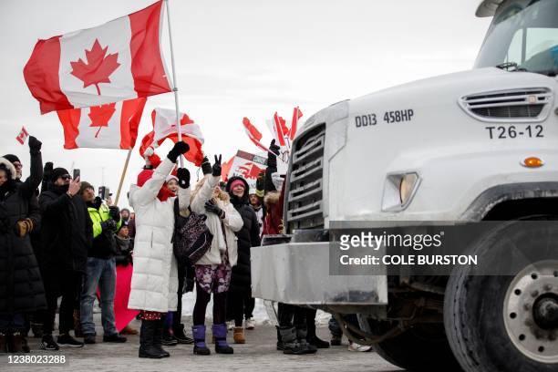 Supporters for a convoy of truckers driving from British Columbia to Ottawa in protest of a Covid-19 vaccine mandate for cross-border truckers,...