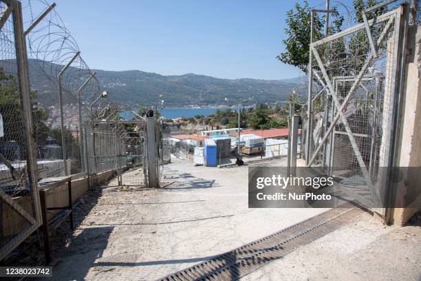 Fence, barbed wire, camera surveillance as seen at the camp. The former official refugee - migrant camp surrounded by barbed wire fence at Vathy of...