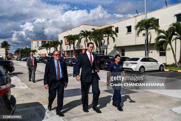 Coast Guard Sector Miami Commander Captain Jo-Ann F. Burdian with Homeland Security Investigations Special Agent Anthony Salisbury arrives for a...