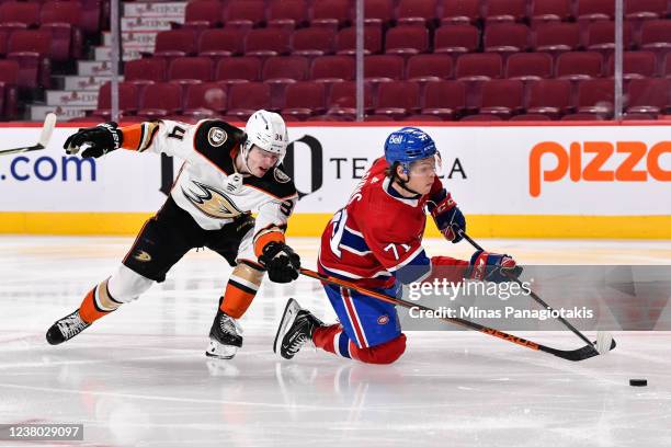 Jake Evans of the Montreal Canadiens skates the puck against Jamie Drysdale of the Anaheim Ducks during the second period at Centre Bell on January...