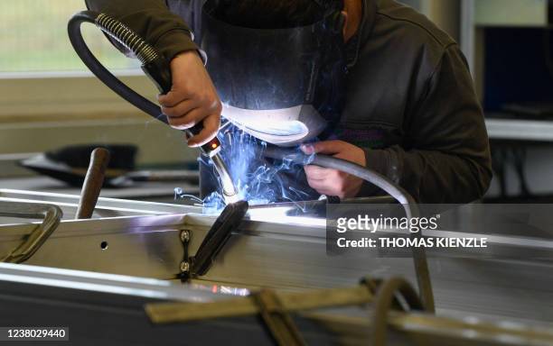Worker welds a ladder in a production hall of German ladder, stool and scaffold-maker Munk Group , at the company's headquarters in Guenzburg,...