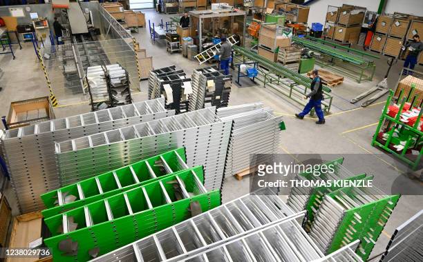 Employees work in a production hall of German ladder, stool and scaffold-maker Munk Group , at the company's headquarters in Guenzburg, southern...
