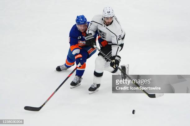 New York Islanders Defenseman Andy Greene and Los Angeles Kings Center Andreas Athansiou battle for the puck during the second period of the National...