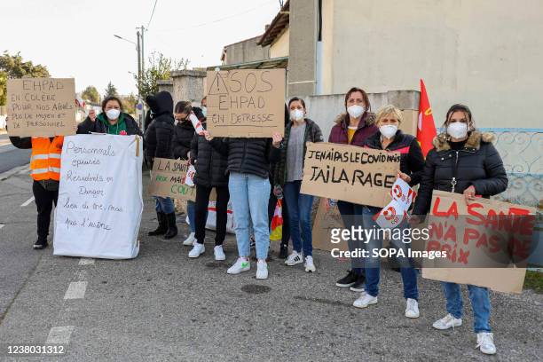 Protesters hold placards during the demonstration. The strike movement follows the publication of the book Les Fossoyeurs on the mistreatment at the...