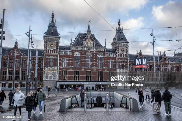 People are seen coming out of the metro underground station in front of Amsterdam Centraal central railway station. Daily life during the lockdown at...