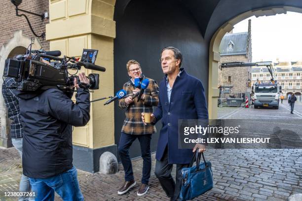 Prime Minister Mark Rutte surrounded by journalists arrives at the Binnenhof for the weekly Council of Ministers in The Hague on January 28, 2022. -...