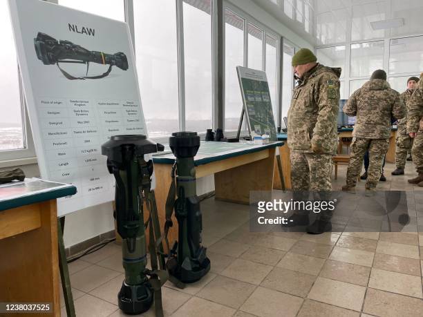Ukrainian Military Forces serviceman looks at Next generation Light Anti-tank Weapon Swedish-British anti-aircraft missile launchers before taking...