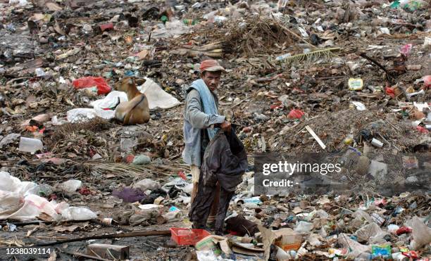 Man collects rubbish at a waste dump about 30kms from East Timor's capital city Dili, 11 July 2005. East Timor President Xanana Gusmao said...