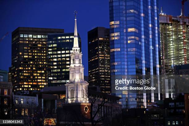 Boston, MA A night time view of some of Boston's towers with a contrast of the Park Street Church steeple in Boston on Jan. 26, 2022. The church was...