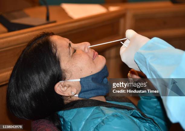 Health worker collects a swab sample for Covid-19 test during a special testing camp for participation on Martyrs Day on January 30 in the memory of...