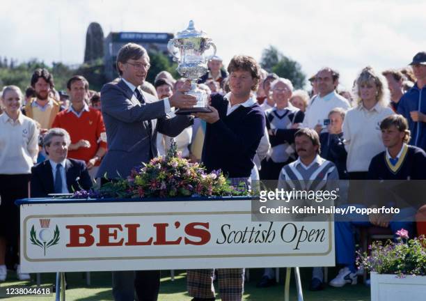 Ian Woosnam of Wales recieves the trophy after winning the Bell's Scottish Open at the King's Course, Gleneagles Hotel on July 11, 1987 in...