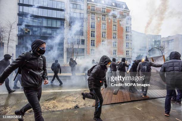 Protesters confront police with glass, stones and parts of makeshift barricades amidst teargas smoke during the demonstration. The end of Sundays...