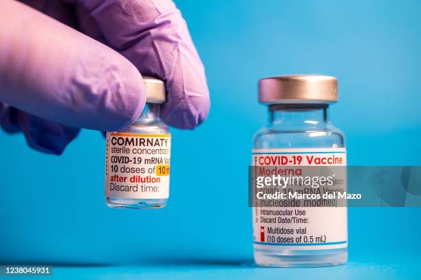 In this photo illustration a vial of COMIRNATY and a vial of Moderna vaccines for coronavirus treatment.