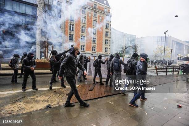 Protesters confront police with glass, stones and parts of makeshift barricades amidst teargas smoke during the demonstration. The end of Sundays...