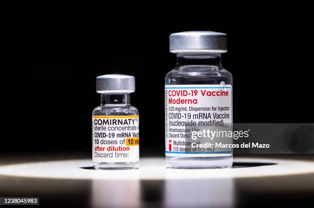 In this photo illustration a vial of COMIRNATY and a vial of Moderna vaccines for coronavirus treatment.