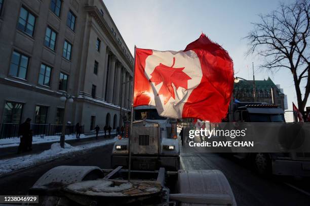 Canadian flag flies upside down on the back of a truck during a "Freedom Convoy" protesting against COVID-19 vaccine mandates and restrictions in...