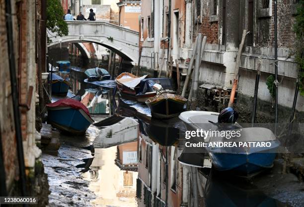 Boats are seen tiede up in a Venice canal on January 29 as exceptionally low tides have drained the lagoon city. - The unusually low tides caused a...