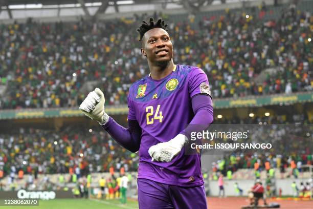 Cameroon's goalkeeper Andre Onana reacts to his team's first goal during the Africa Cup of Nations 2021 quarter final football match between Gambia...