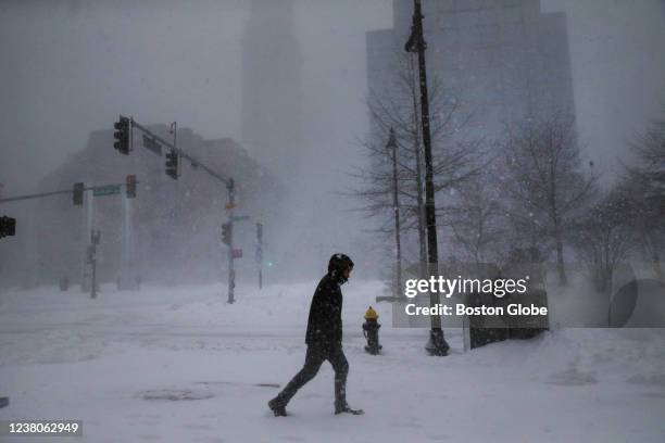 Boston, MA A lone man walks on Atlantic Ave. During the snowstorm in downtown Boston, MA on January 29, 2022. A large storm bears down on New...