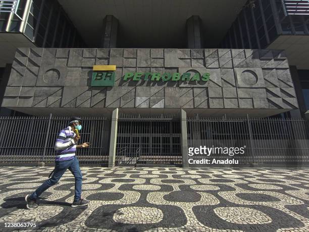 Man walks past the headquarters of Brazilian Oil Company, Petrobras as gasoline price hiked in Rio de Janeiro, Brazil on January 28, 2022. The poor...