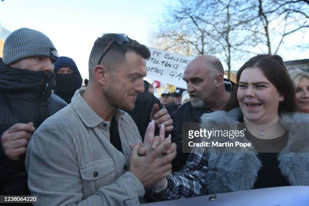 Tommy Robinson holds hands with grooming gang survivor Nicole as they walk into town on January 29, 2022 in Telford, England. Tommy Robinson launches...