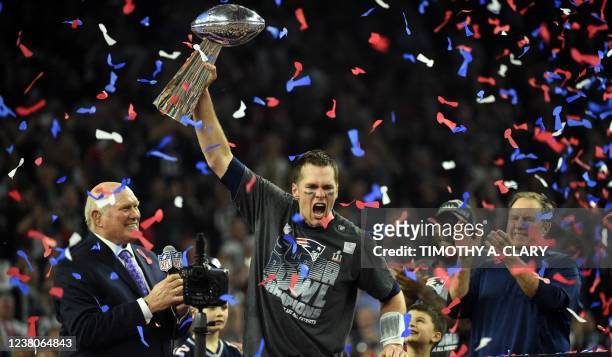 In this file photo taken on February 05 Tom Brady, #12 of the New England Patriots, holds the Vince Lombardi Trophy after defeating the Atlanta...