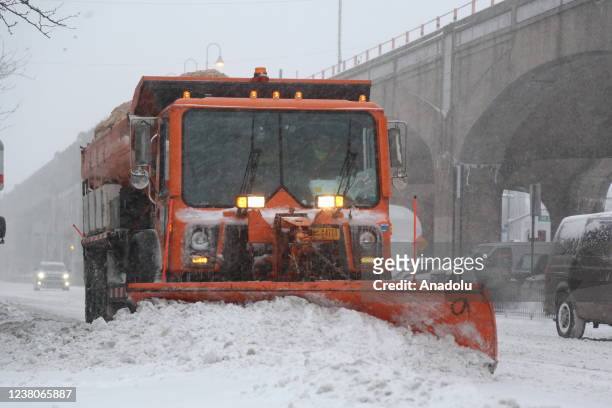 Snowplough vehicle clears snow-covered road as powerful Nor'easter and winter storm affects daily life in New York City, United States on January 29,...