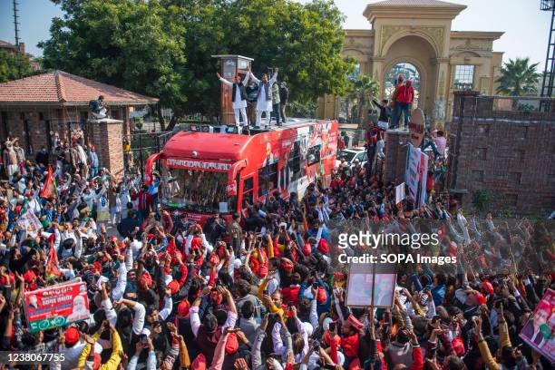 Akhilesh Yadav and Jayant Chaudhary stand on bus roof wave at the party supporters during their joint road show for the upcoming assembly election...