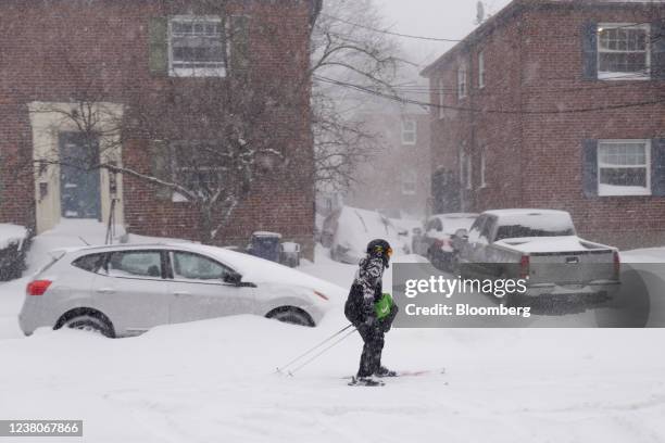 Resident skis down a street during a blizzard in Boston, Massachusetts, U.S., on Saturday, Jan. 29, 2022. A powerful winter storm is whipping the...