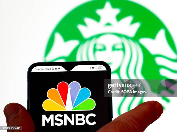 In this photo illustration, the MSNBC logo is seen displayed on a smartphone screen with the Starbucks coffee logo in the background.