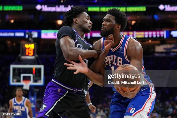 Joel Embiid of the Philadelphia 76ers drives to the basket against Damian Jones of the Sacramento Kings in the first half at the Wells Fargo Center...