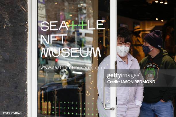 Visitors exit the Seattle NFT Museum during its opening weekend in Seattle, Washington on January 29, 2022. - Using the blockchain technology behind...