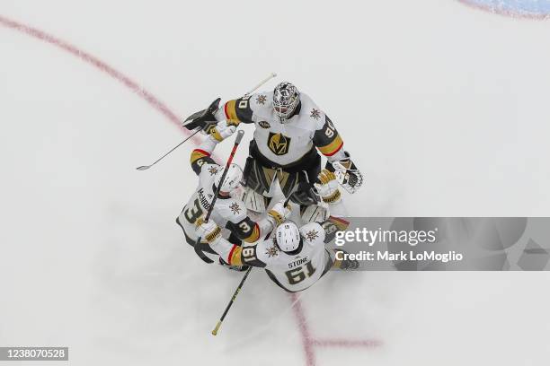Goalie Robin Lehner, Brayden McNabb, and Mark Stone of the Vegas Golden Knights celebrate the win against the Tampa Bay Lightning at Amalie Arena on...