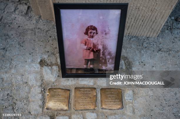 Photograph of Holocaust survivor Inge Auerbacher's childhood friend Ruth Nelly Abraham, then aged three, is placed near the so-called "Stolpersteine"...