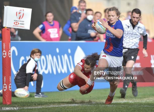 France's Lina Guerin is tackled by Canada's Sabrina Poulin during the Women's HSBC World Rugby Sevens 2022 match between Canada and France at the La...