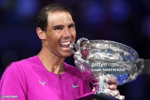 Spain's Rafael Nadal smile as he holds the Norman Brookes Challenge Cup trophy following his victory against Russia's Daniil Medvedev in their men's...